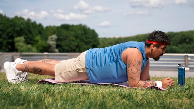 Hombre de tiro completo haciendo ejercicio al aire libre