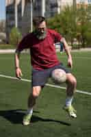 Foto gratuita hombre de tiro completo jugando al fútbol