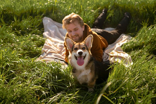 Hombre de tiro completo con perro en la naturaleza