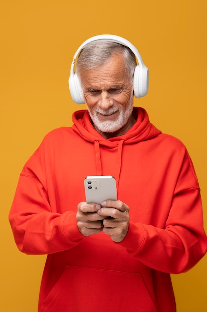 Hombre de tiro medio con auriculares y teléfono