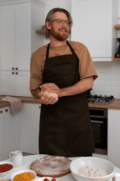 Foto gratuita hombre de tiro medio cocinando pizza