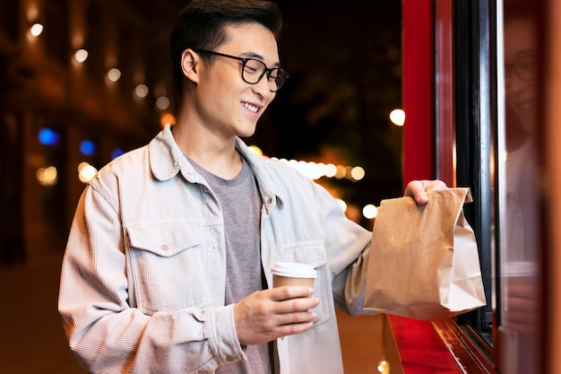 Hombre de tiro medio sosteniendo una bolsa de papel