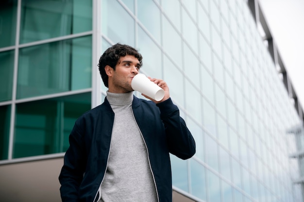 Hombre de tiro medio tomando café