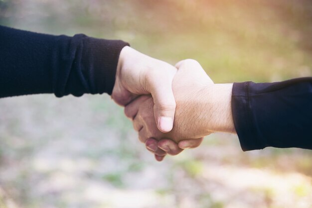 Hombre tocando / sosteniendo la mano juntos para el concepto de trabajo de compromiso de éxito