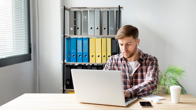 Foto gratuita hombre trabajando en la computadora portátil