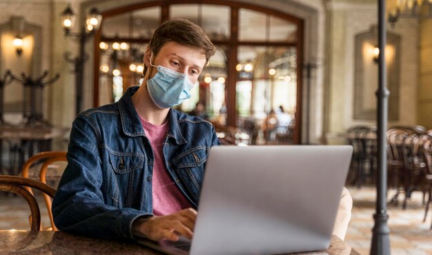 Hombre trabajando en interiores mientras usa una mascarilla