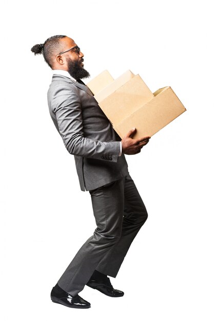 Hombre en traje cargando un montón de cajas