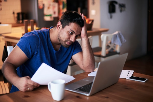 Hombre usando una computadora portátil en casa