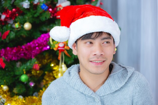 hombre vestido con sombrero de navidad sonriendo con alegría