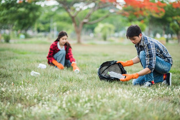 Hombres y mujeres se ayudan mutuamente para recolectar basura.