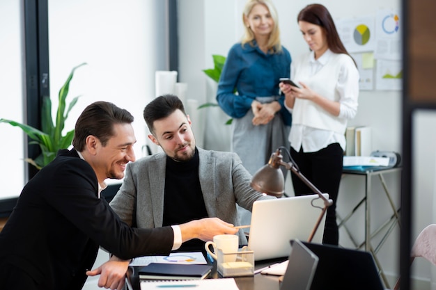 Hombres y mujeres de tiro medio en el trabajo.