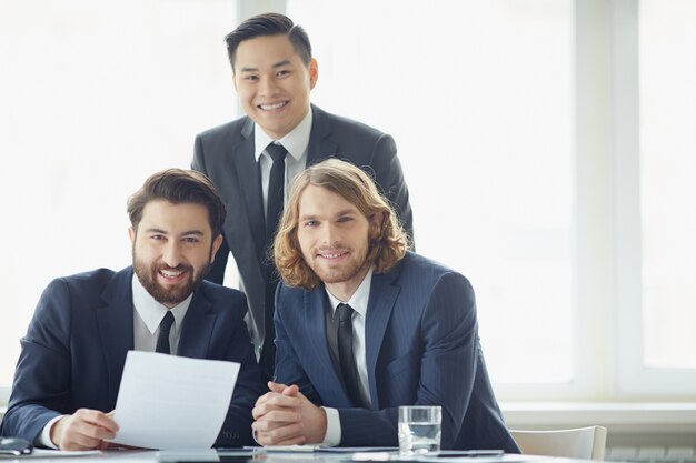 Hombres de negocios alegres trabajando en equipo