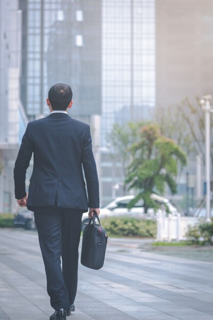 Los hombres de negocios llevar ordenadores portátiles en el estacionamiento