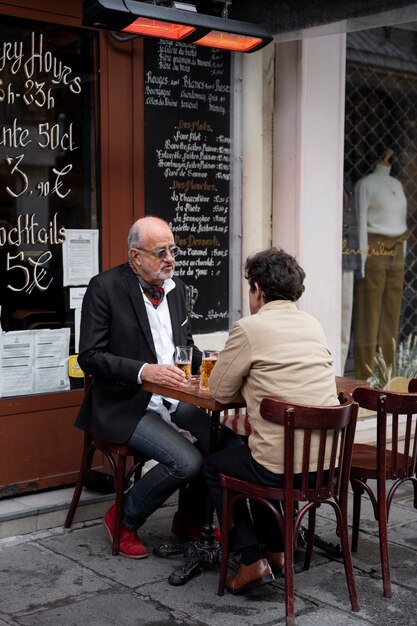 Hombres de tiro completo sentados a la mesa juntos