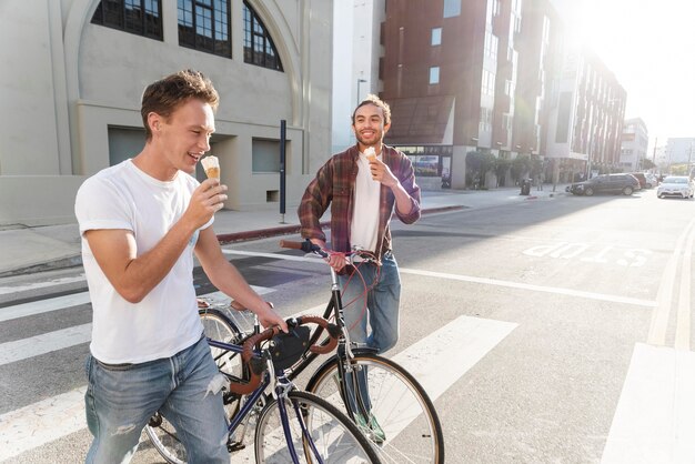 Hombres de tiro medio comiendo helado