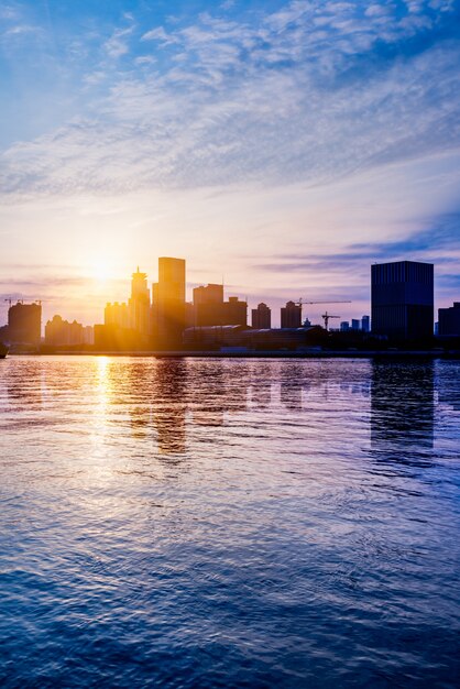 Horizonte de la ciudad por el río contra el cielo nublado