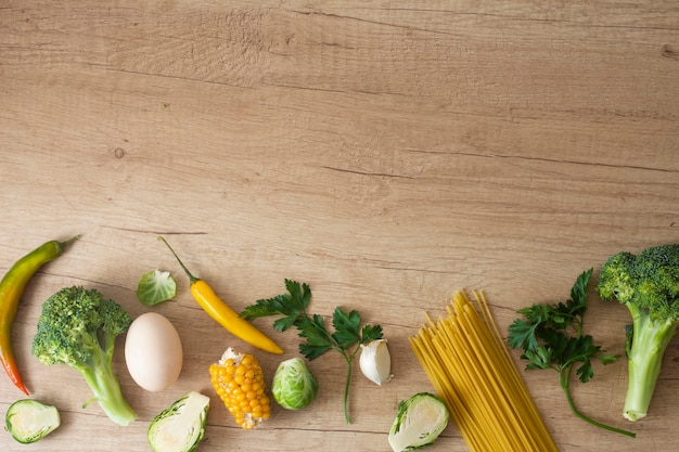 Foto gratuita huevo de verduras y maíz en la mesa con espacio de copia