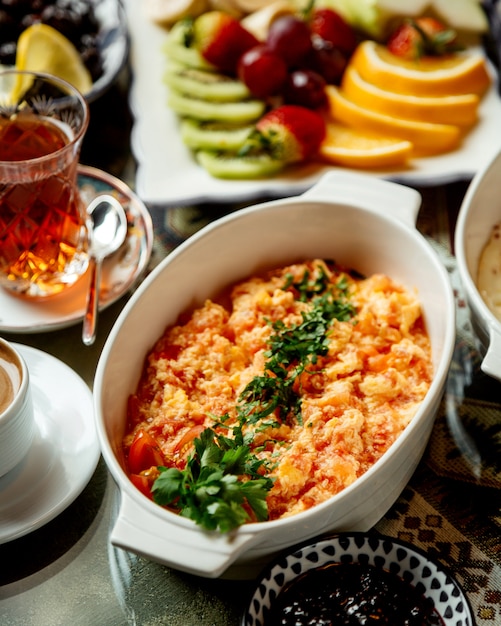 Huevos fritos con tomate y hierbas con té negro.