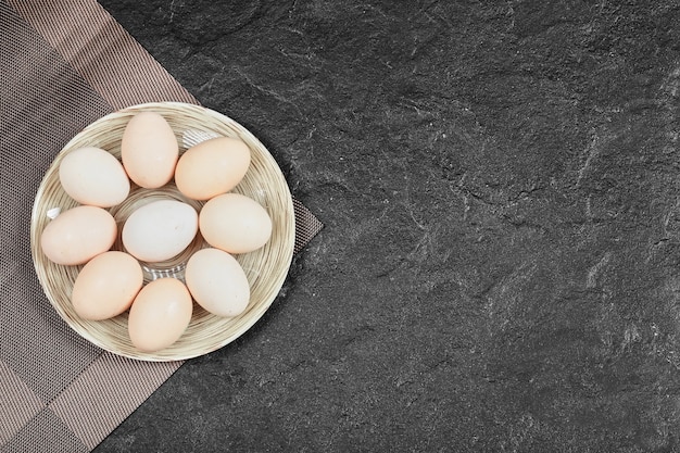 Huevos de gallina en plato de cerámica. Vista desde arriba.