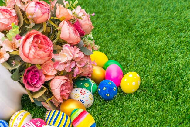 Huevos de Pascua con la flor artificial de la hierba verde fresca