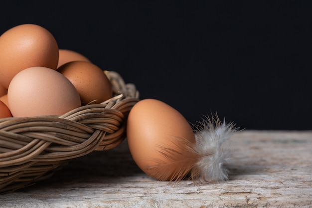 Huevos y plumas en una canasta