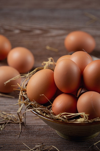 Huevos en tazas sobre arpillera con pasto seco.