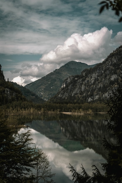 Foto gratuita impresionante foto de las montañas con un lago en primer plano bajo un cielo nublado