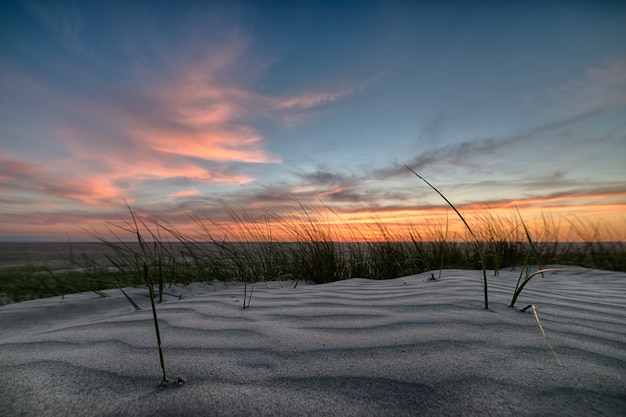 Impresionante puesta de sol sobre la playa con una orilla arenosa