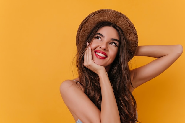 Increíble joven blanca con sonrisa inspirada mirando hacia arriba