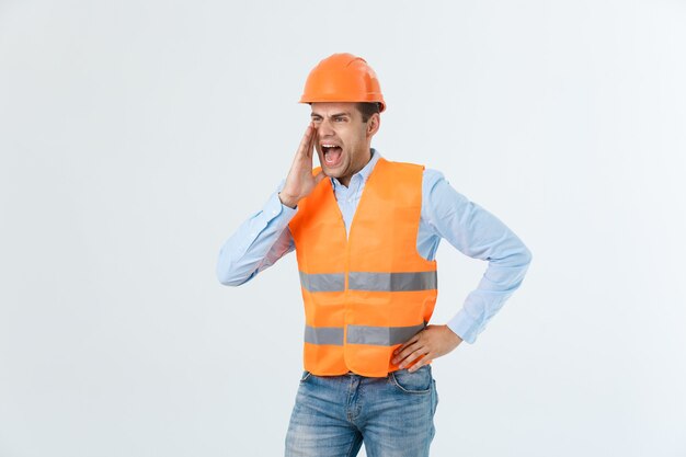 Ingeniero enojado con emoción de cara enojada gritando a alguien levantando ambas manos, aislado en un fondo blanco.