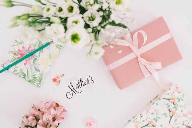 Inscripción de madres con flores y caja de regalo.