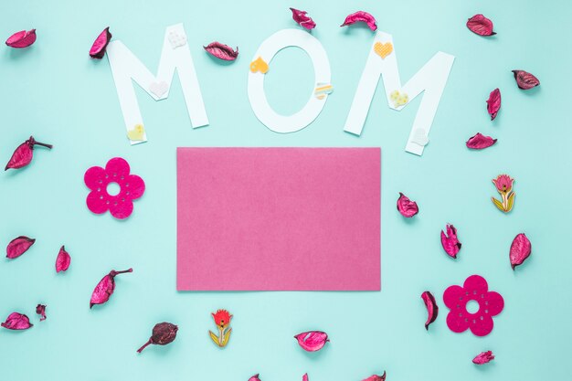 Inscripción de mamá con pétalos de papel y flores.