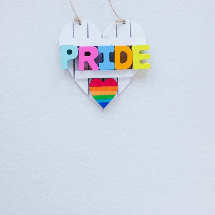 Foto gratuito inscripción de orgullo con el corazón del arco iris