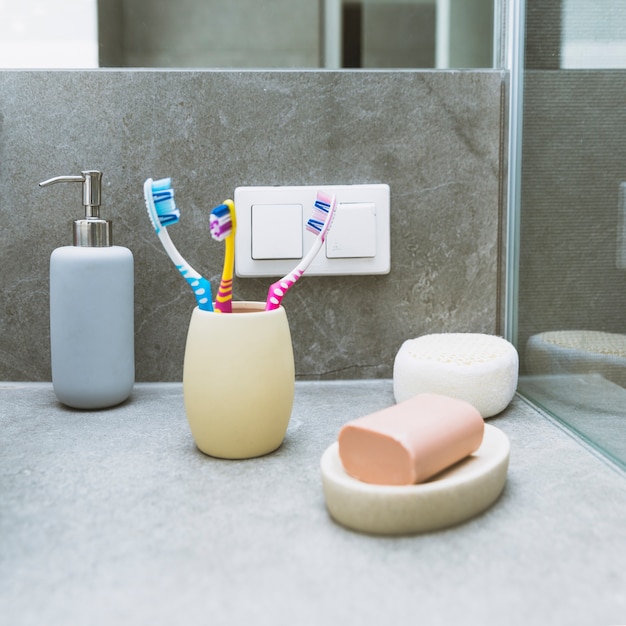 Foto gratuita jabón y cepillos de dientes en estante