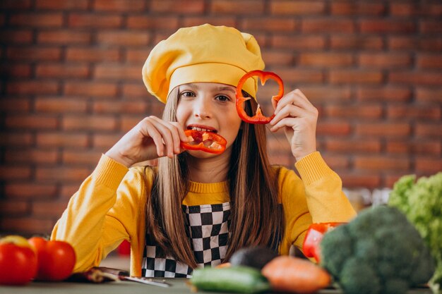 Joven adolescente preparando ensaladas para el desayuno en la cocina