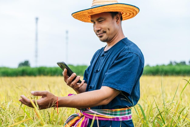 Joven agricultor asiático con smartphone