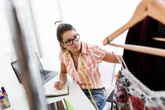 Joven y bella mujer que trabaja en el estudio de diseño.