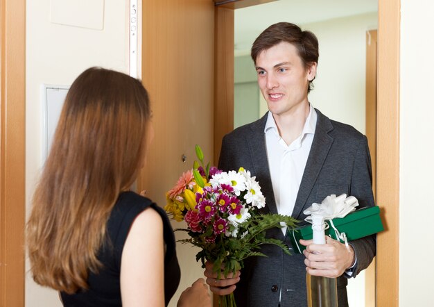 Joven dando regalos a la mujer