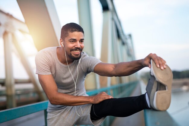 Joven deportista sonriente preparándose para correr