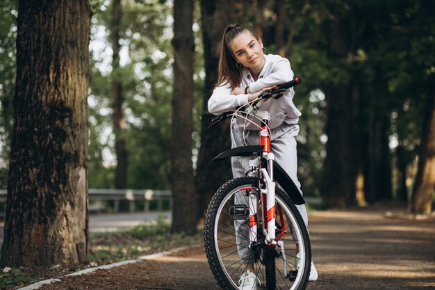 Joven deportiva montando bicicleta en el parque