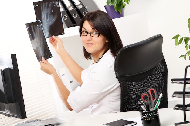 Foto gratuita joven doctora está mirando rayos