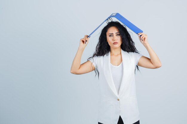 Joven empresaria sosteniendo una carpeta azul