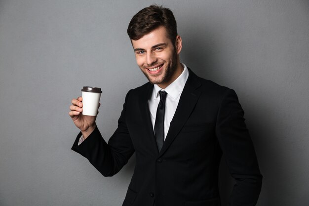 Joven empresario exitoso disfrutando su café de la mañana,