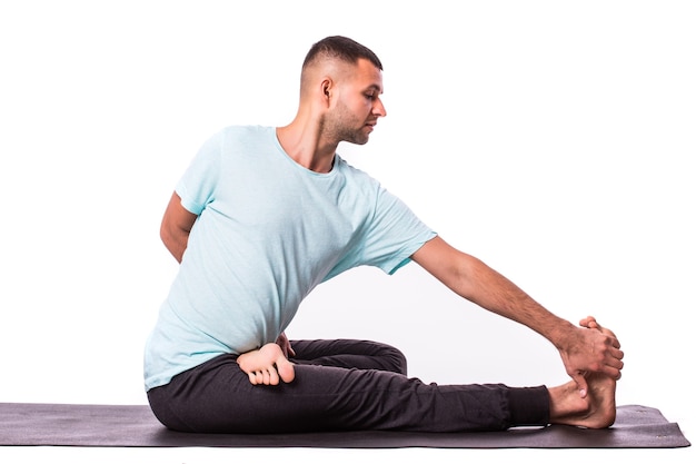 Joven está haciendo yoga aislado sobre fondo blanco.