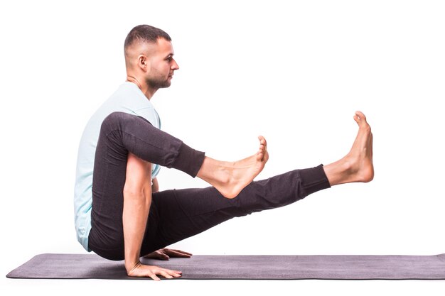 Joven está haciendo yoga aislado sobre fondo blanco.