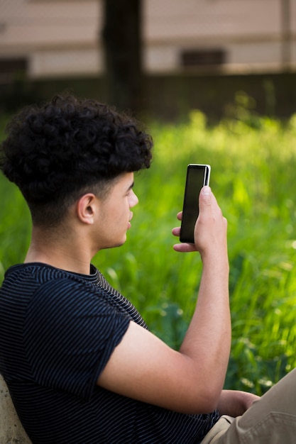 Foto gratuita joven étnico tomando foto en la calle