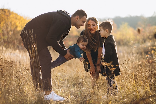 Joven familia con dos hijos juntos en el parque