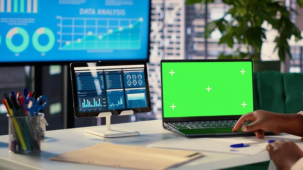Joven gerente general utilizando la pantalla verde y evaluando las métricas de rendimiento