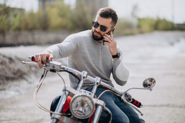 Joven guapo en moto viajando