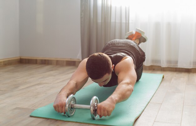 Joven haciendo ejercicios deportivos en casa